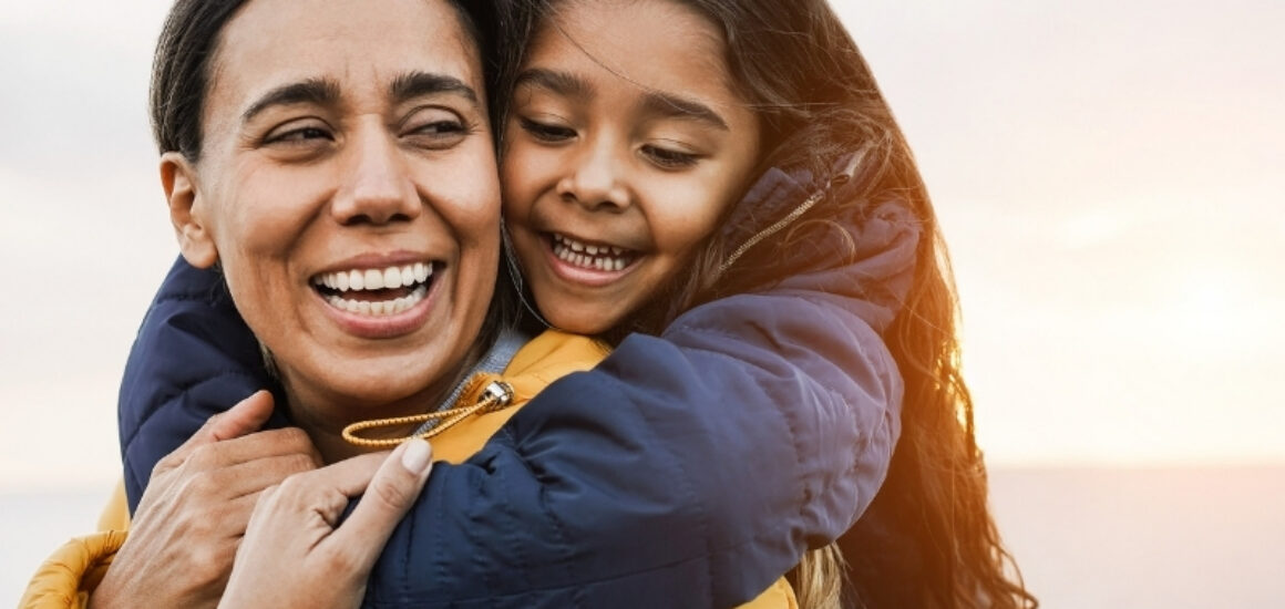 Mother giving daughter a piggyback ride.