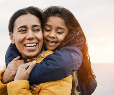Mother giving daughter a piggyback ride.