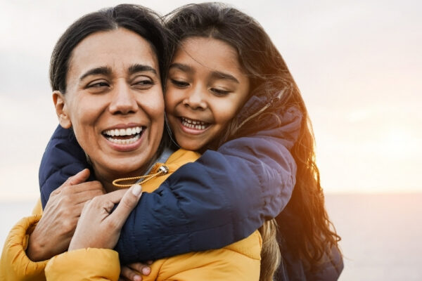 Mother giving daughter a piggyback ride.