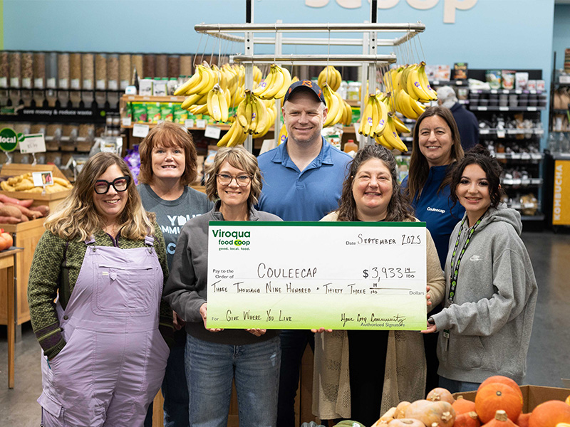 Couleecap staff accept donation from Viroqua Food Coop